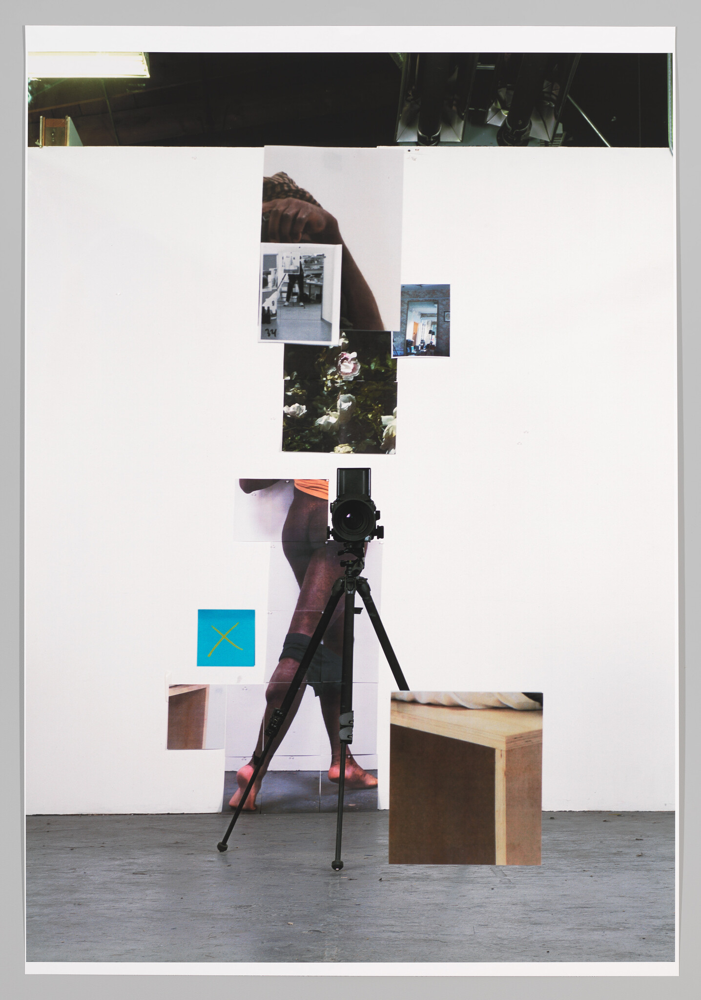 Camera on tripod faces a white wall collage showing a person's legs and small photos.