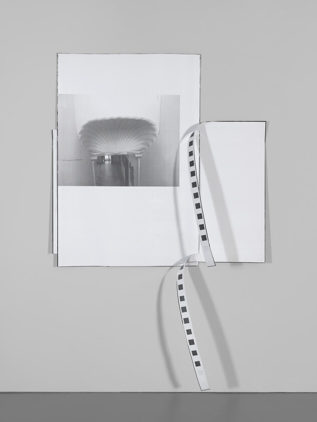 A black and white abstract artwork with a shell-like shape and two curled strips with square patterns.