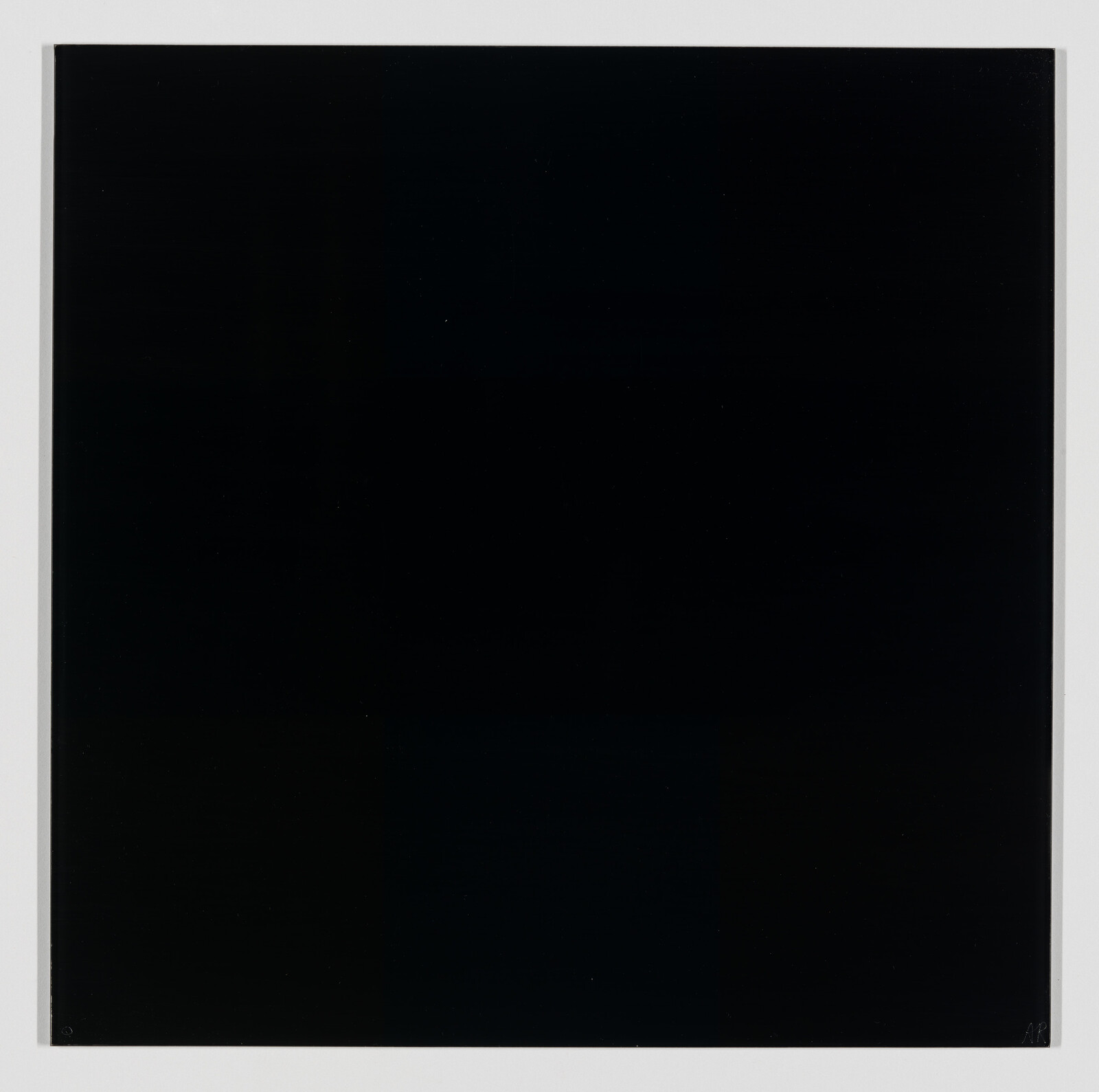 A large flat black square panel centered on a white background with thin white border.