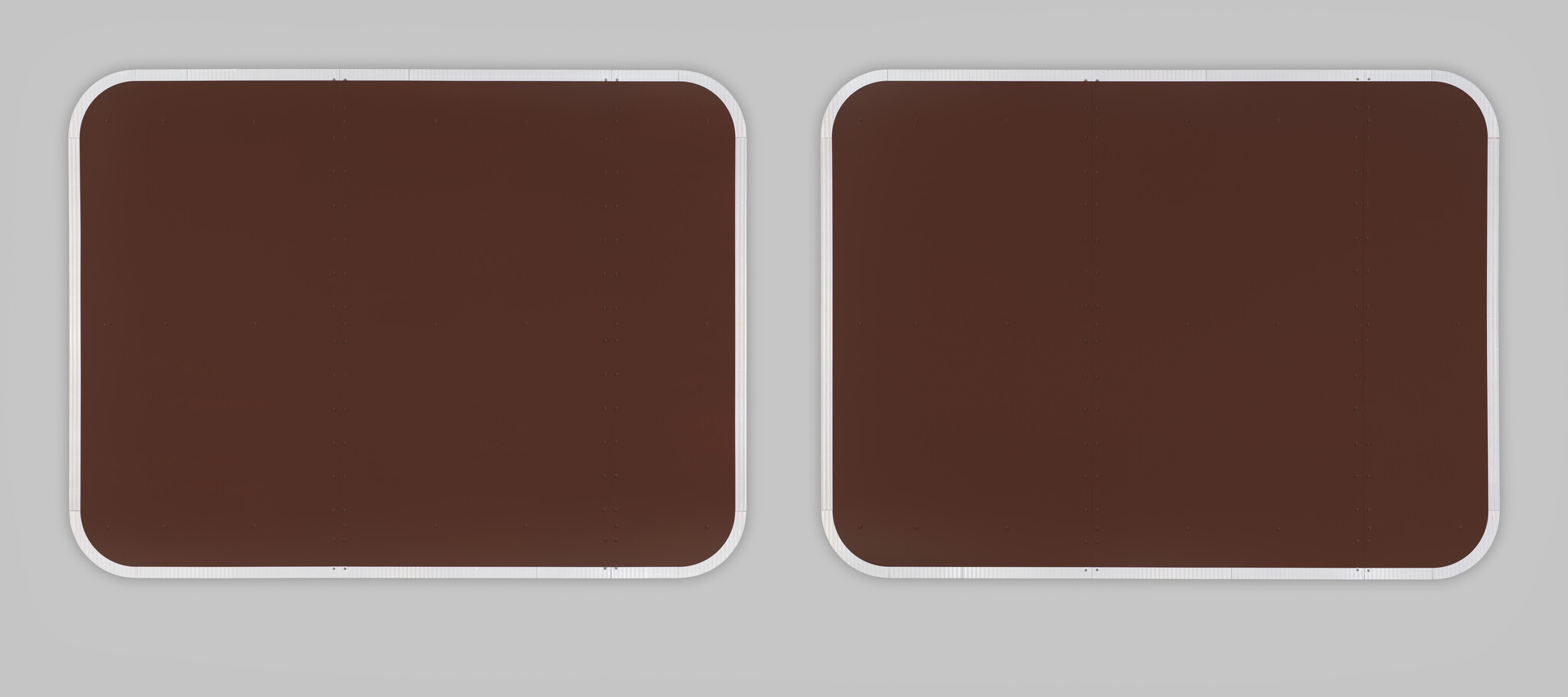 Two monochrome brown rectangular shapes like empty signs, with reflective tape around their edges