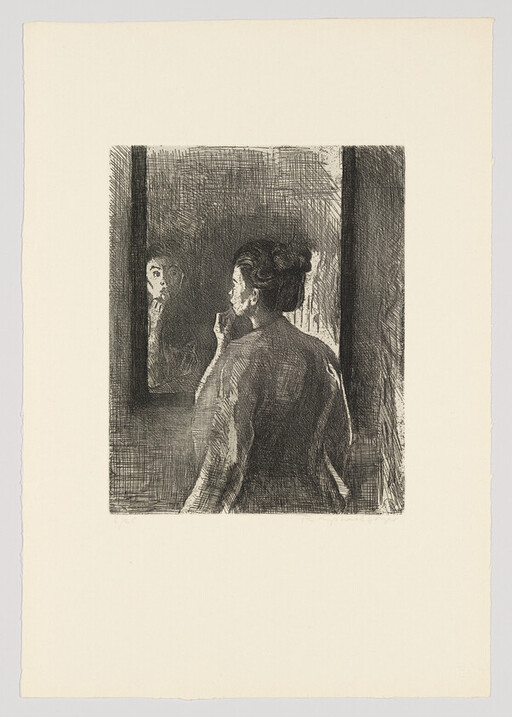 A woman stands before a mirror, touching her chin as she studies her reflection.
