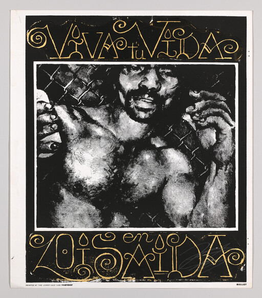Shirtless man presses against a chain-link fence with raised hands under stylized gold text.