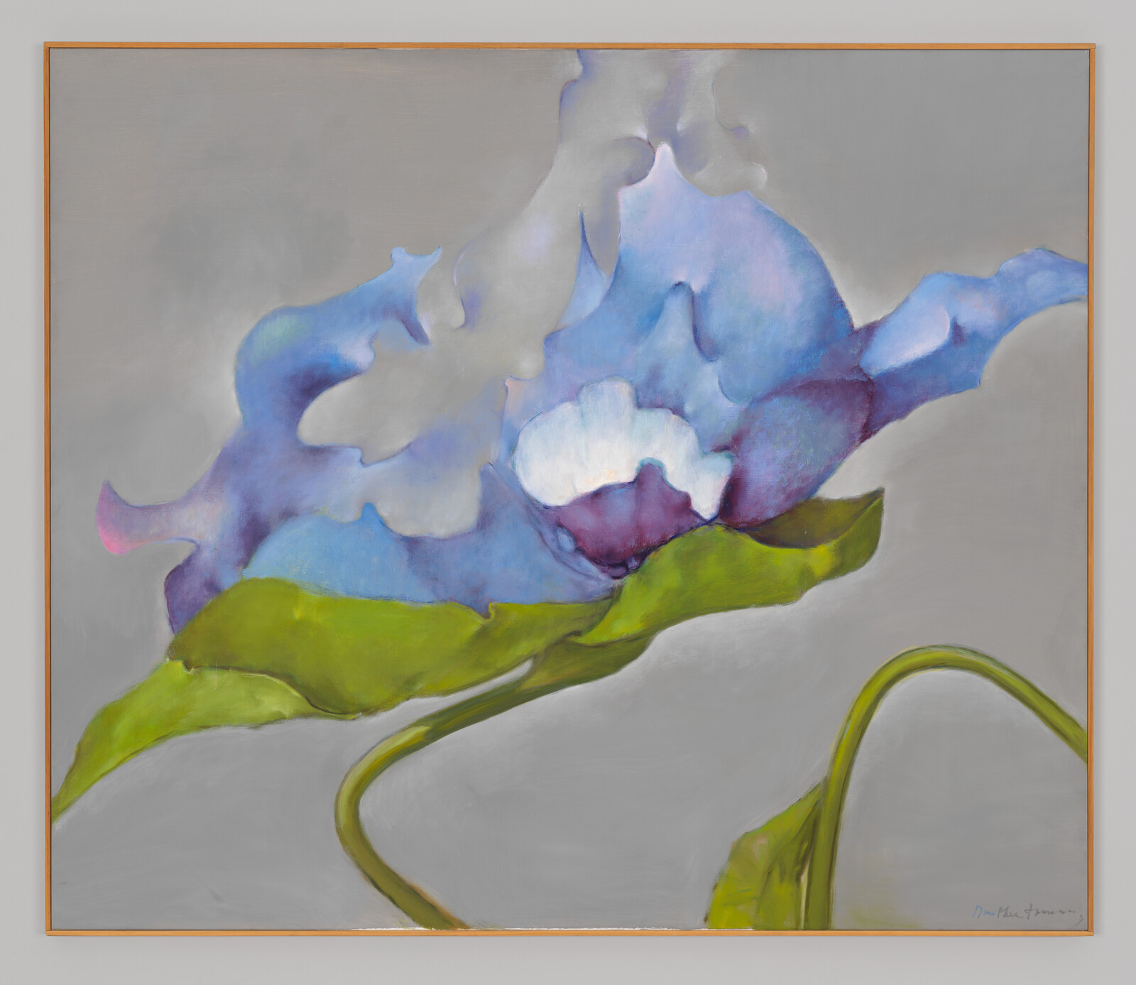 A large blue and purple abstract flower with green leaves on a soft gray background.