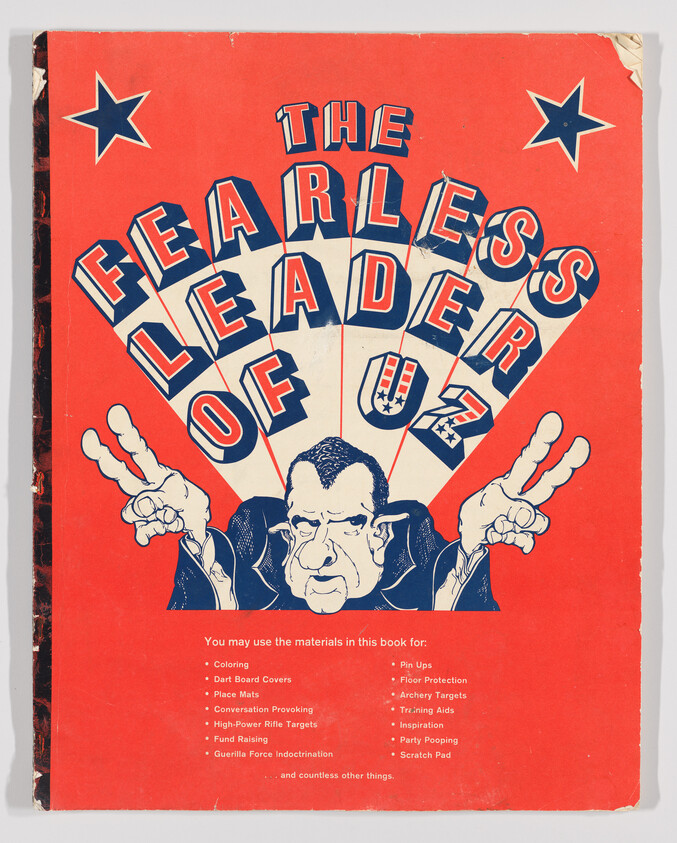 Bold red poster showing a caricatured man making two peace-sign gestures under the title "The Fearless Leader of U.S.".