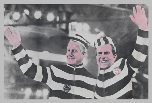 Two men in black-and-white striped prisoner outfits wave, each wearing political campaign buttons.