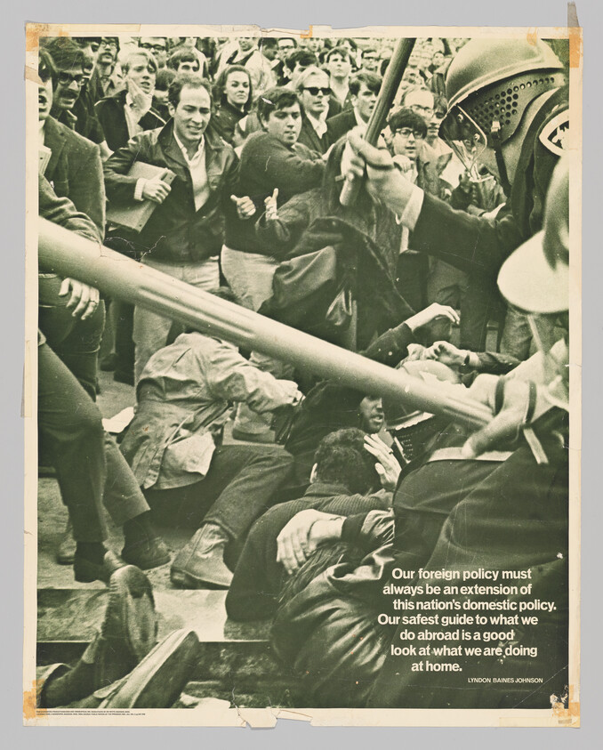 Crowd of protesters clashing with riot police as officers strike with batons.