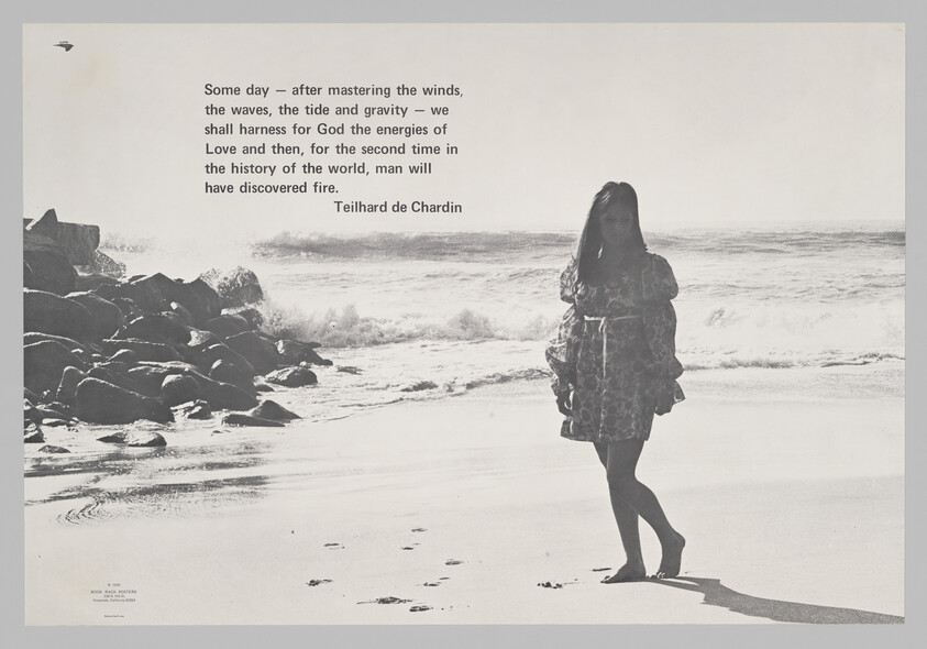 A young woman stands on a sunlit beach beside a printed quote about harnessing the energies of love.