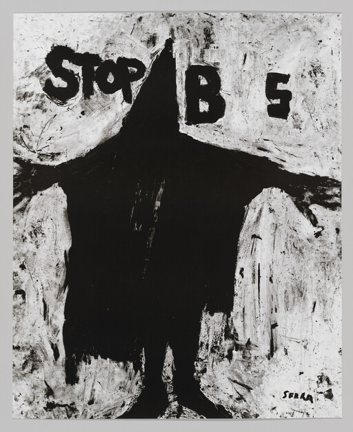A large black hooded figure with outstretched arms in front of graffiti reading "STOP".