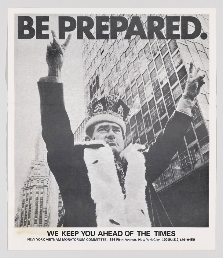 A black and white poster with the phrase "BE PREPARED" in large letters at the top. Below is a photo of a man wearing a crown and a fur-trimmed cape, raising his right hand with a peace sign. In the background, there are tall buildings, suggesting an urban setting. At the bottom, text reads "WE KEEP YOU AHEAD OF THE TIMES" with the address and phone number of the New York Vietnam Moratorium Committee.