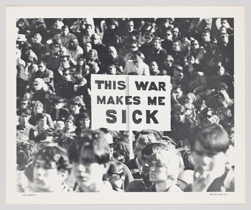 Crowd of protesters holding a sign that reads "This war makes me sick."