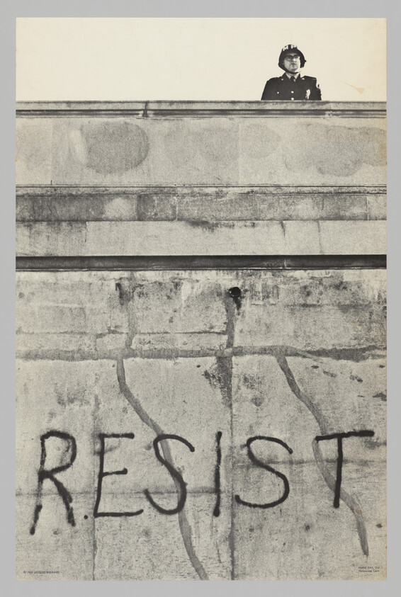 A police officer stands on a wall above large graffiti reading "RESIST."