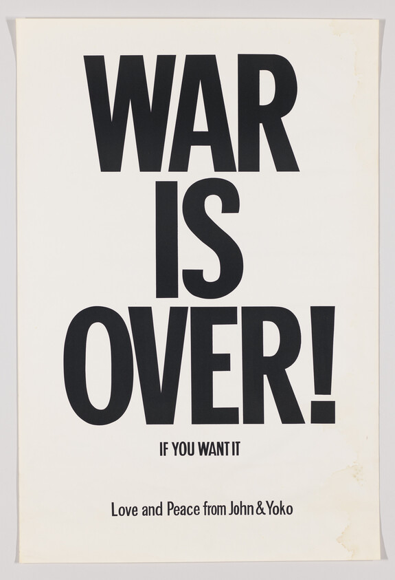 A poster with bold black text on a white background that reads "WAR IS OVER!" in large letters, followed by "IF YOU WANT IT" in smaller text below. At the bottom, it says "Love and Peace from John & Yoko." The poster has a vintage look with some discoloration on the edges.