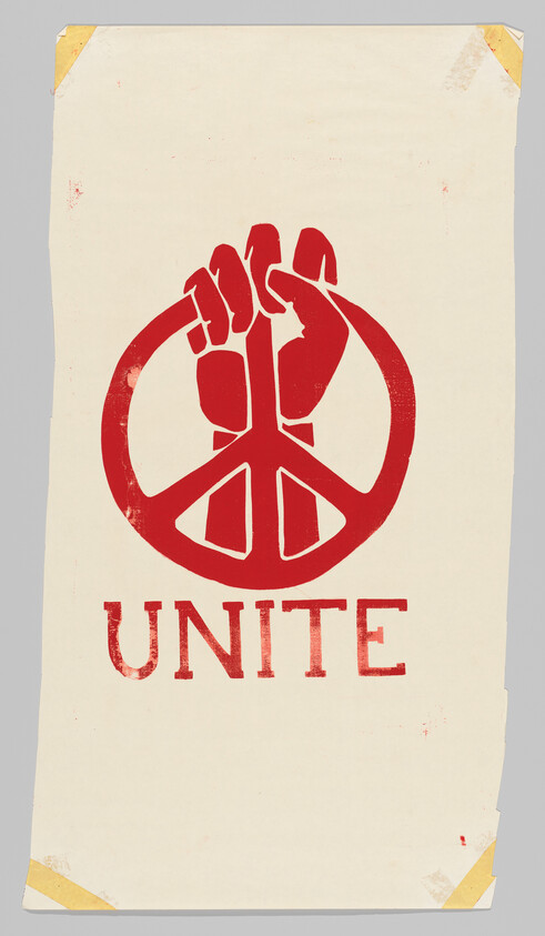 Red fist forming a peace symbol above the word "UNITE" on a worn poster.