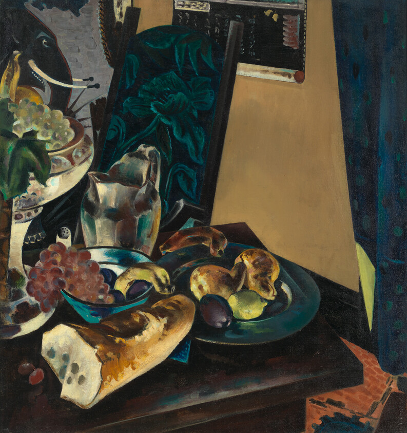 A still-life table with a loaf of bread, bowl of fruit, grapes, and a metal pitcher.