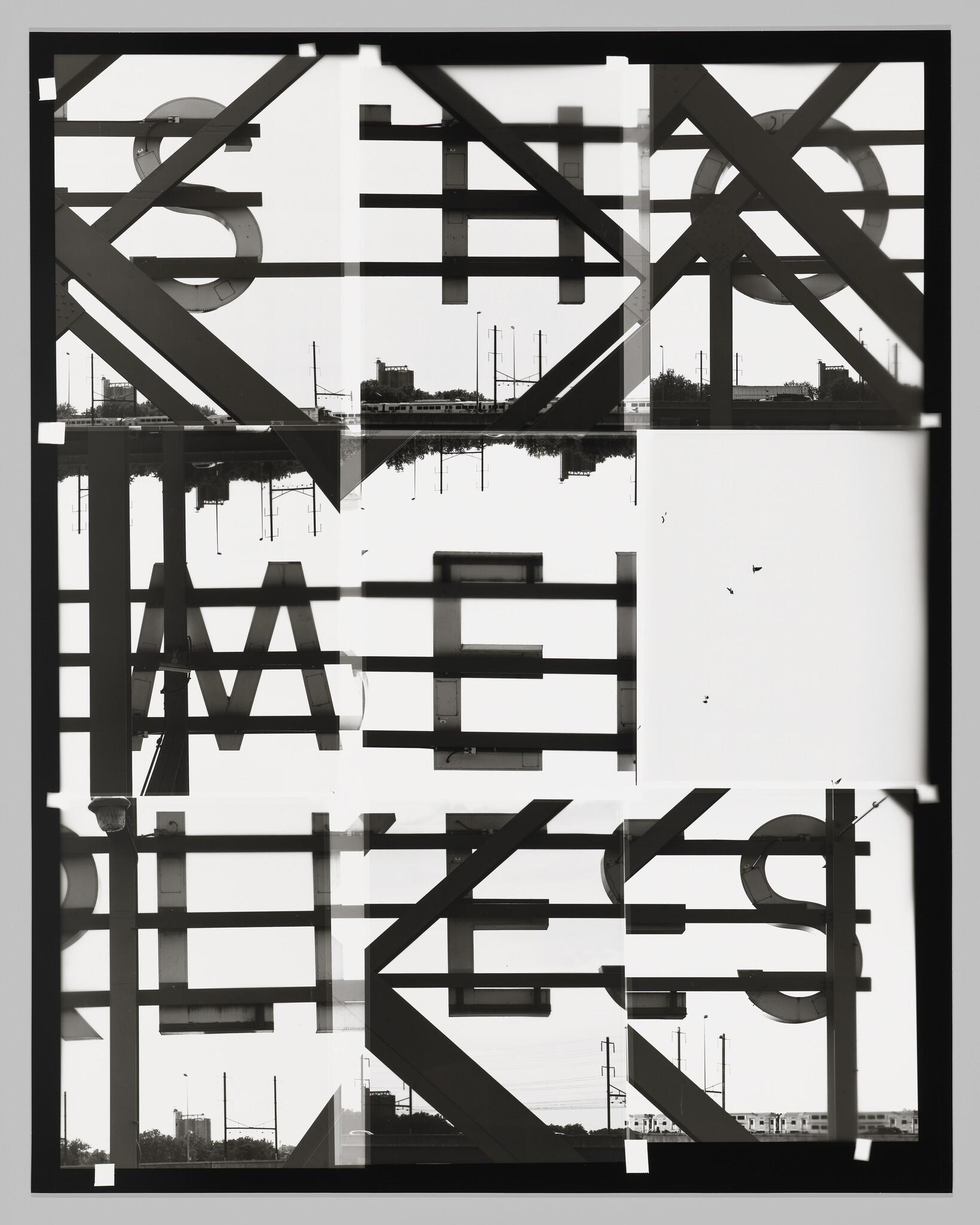 Overlapping metal sign letters and structural beams create a mirrored, fragmented urban silhouette with train tracks.