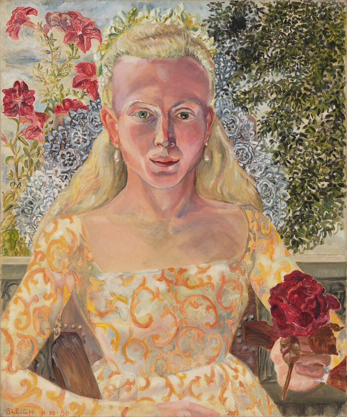 A blonde woman in a patterned dress sits holding a red rose against a floral background.