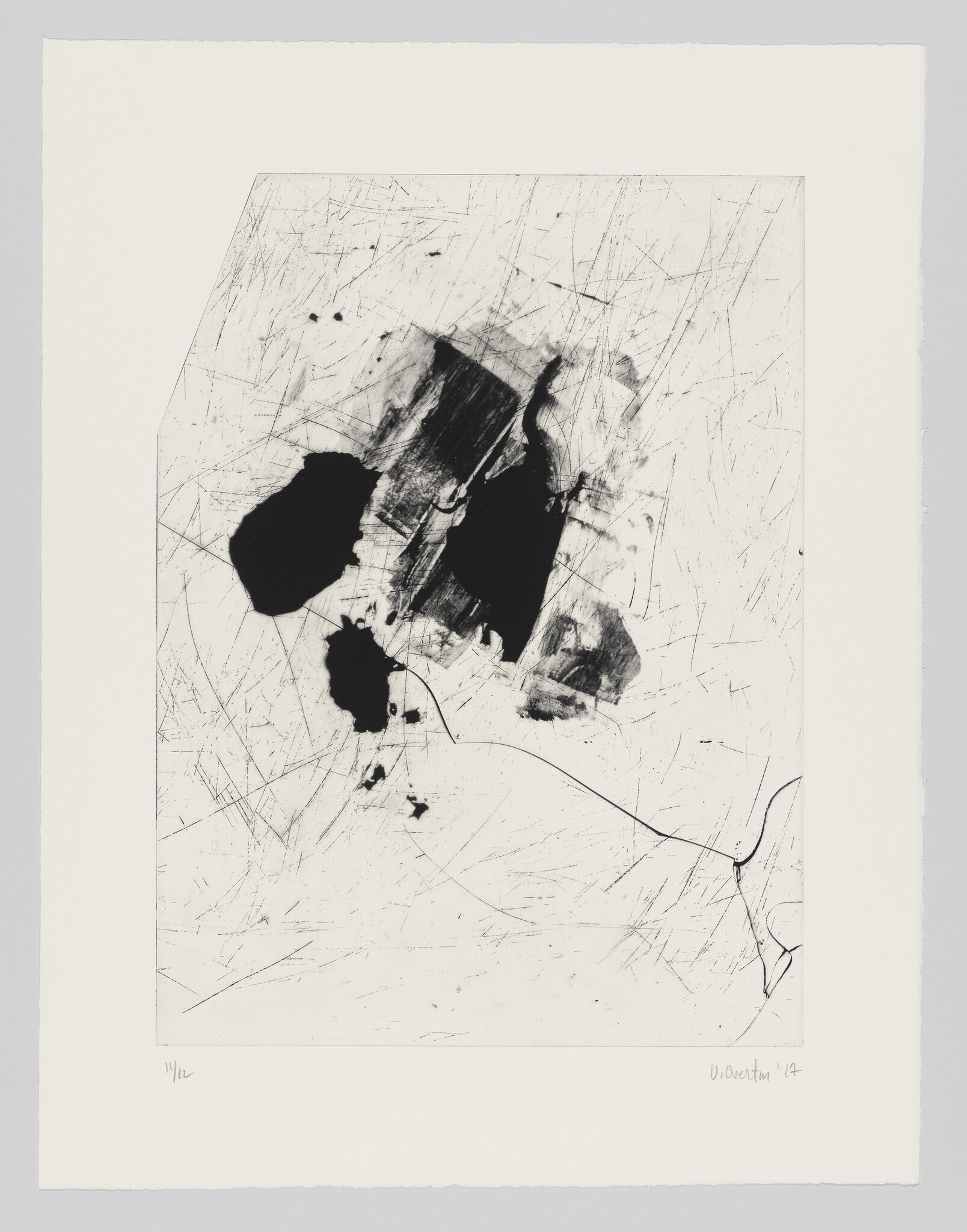 Abstract black ink blots and fine scratches scattered across a white sheet with torn edges.