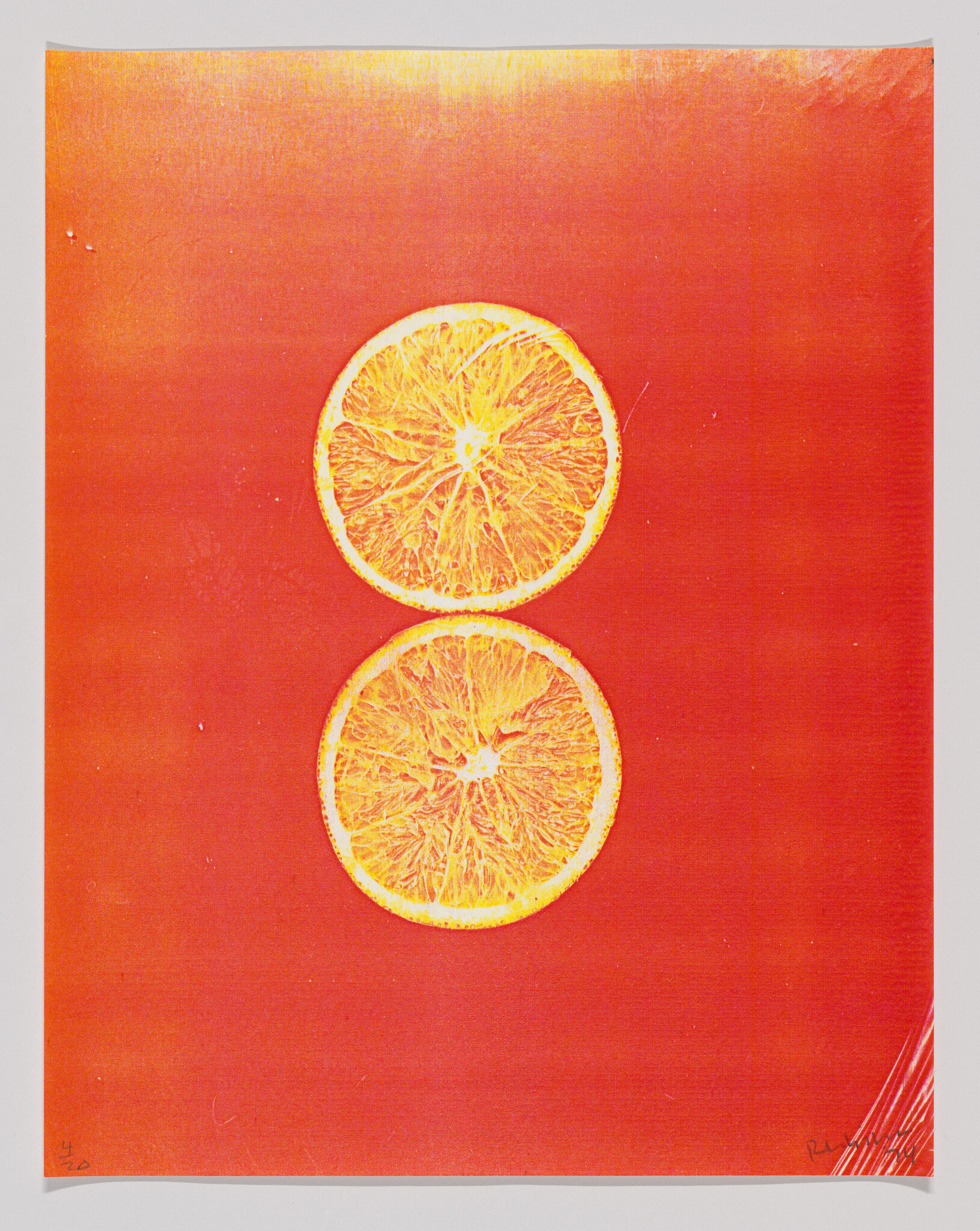 Two orange slices centered on a vibrant red background with a subtle texture.