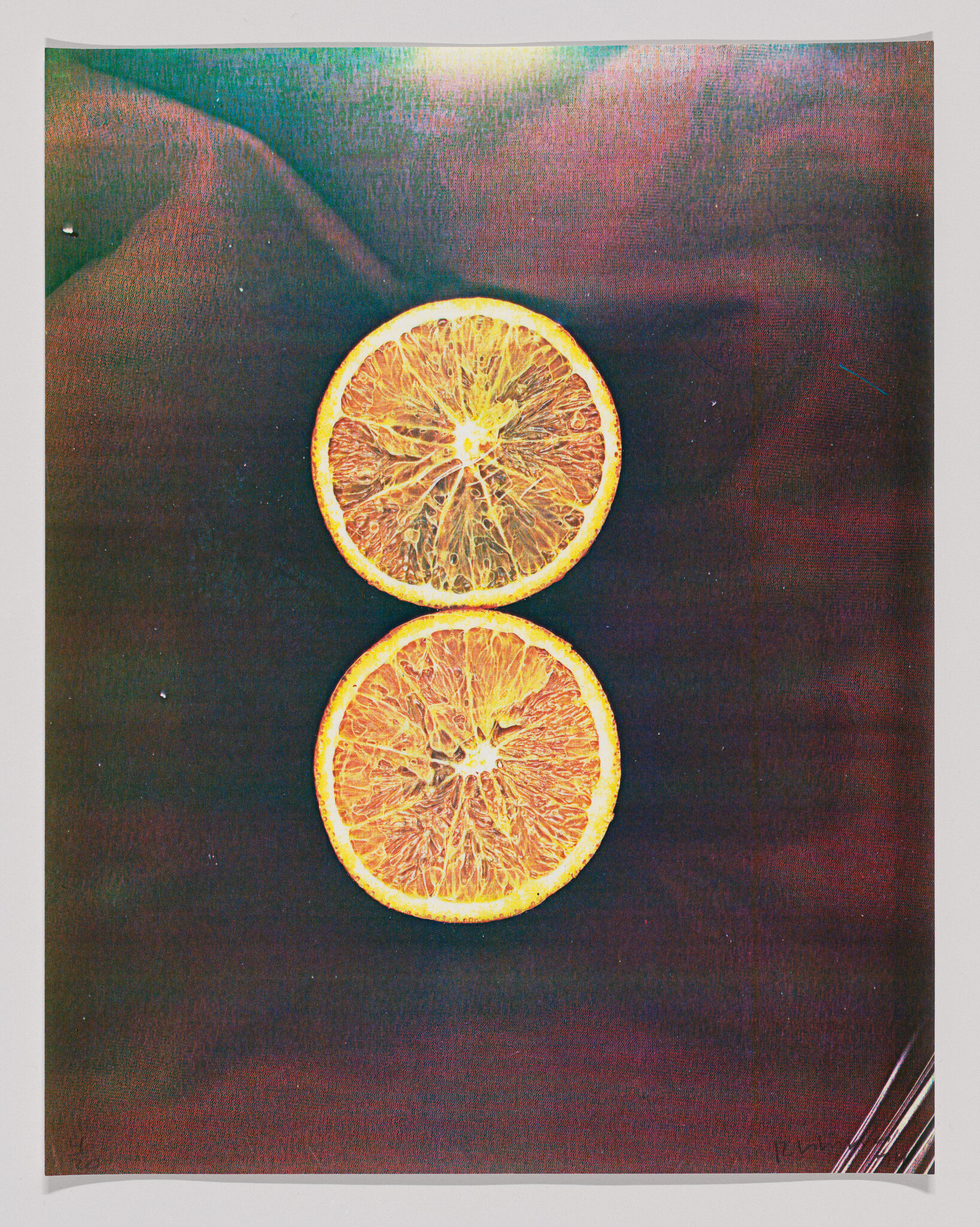 Two orange slices stacked vertically on a dark textured background.