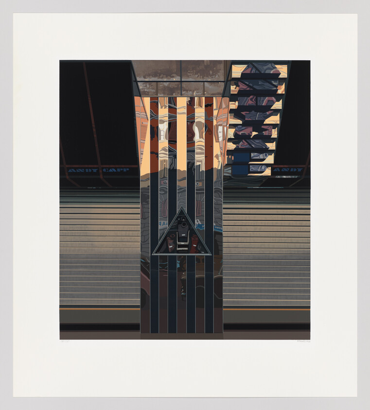 Central reflective column with vertical strips and triangular mirror reflecting a person in an urban station.