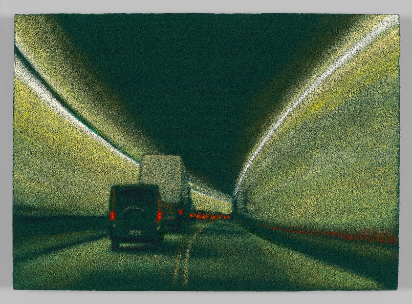Two vehicles and a truck drive through a dimly lit tunnel with glowing overhead lights.