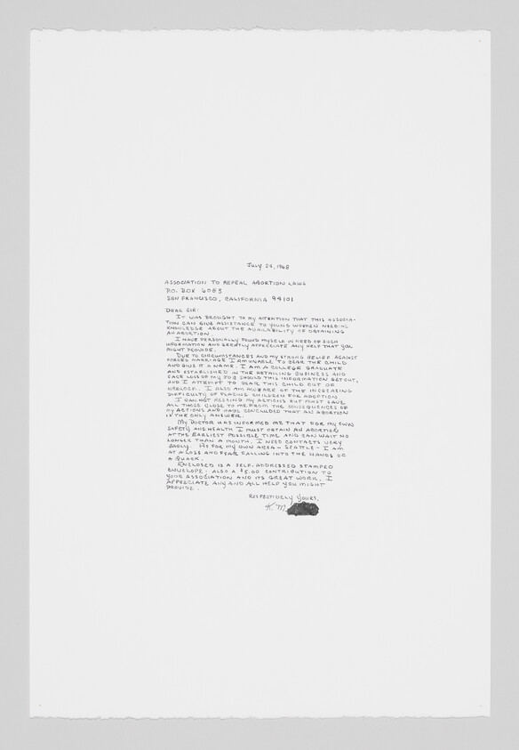 Handwritten letter centered on a large white sheet, with small dense text and a signature.