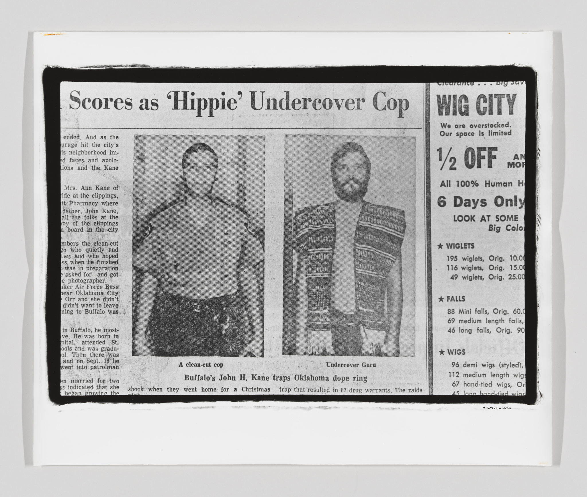 A black and white photograph of a newspaper article with the headline "Scores as 'Hippie' Undercover Cop" featuring two images of the same man: on the left, he is clean-shaven and dressed in a formal shirt and tie, labeled "A clean-cut cop," and on the right, he has a full beard and long hair, wearing a patterned garment, labeled "Undercover Guru." To the right of the article is an advertisement for a wig sale at "WIG CITY" with various discounts listed. The newspaper is slightly curled at the edges, indicating it's a physical copy.