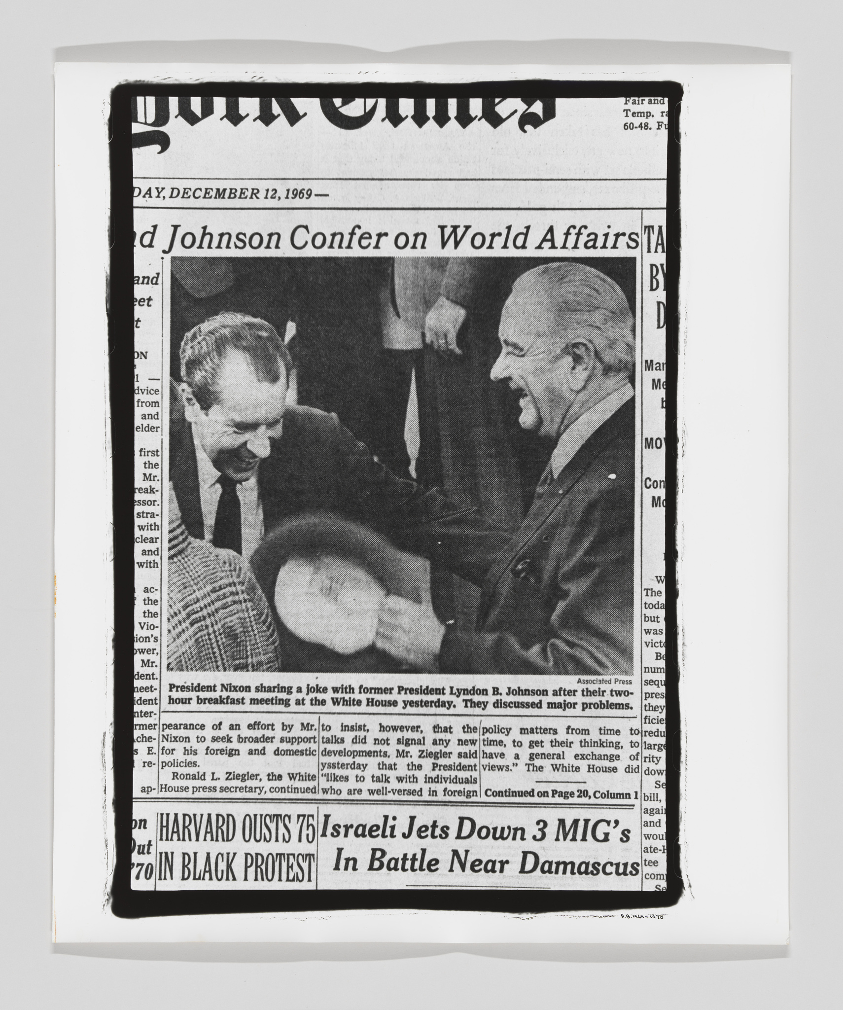 A black and white photograph of a newspaper clipping from The New York Times, dated December 12, 1969, featuring President Nixon sharing a joke with former President Lyndon B. Johnson at a White House event, with both men smiling and engaging in conversation. The headline reads "Nixon and Johnson Confer on World Affairs." Other news headlines are visible below the main article.