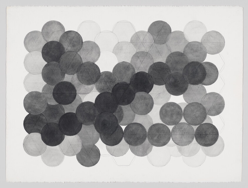A grid of overlapping gray circles with varying tones forming a honeycomb-like pattern.