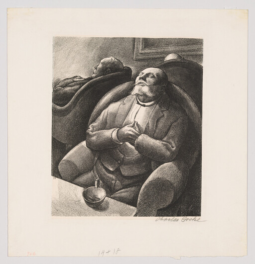 A bearded man reclines in an armchair with hands clasped while another man rests behind him.