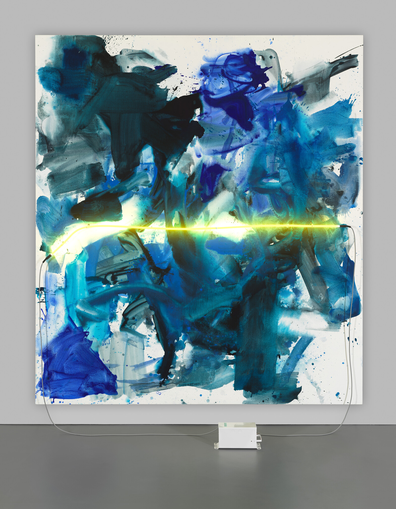 Large abstract blue painting with a glowing yellow horizontal neon light and visible power box.