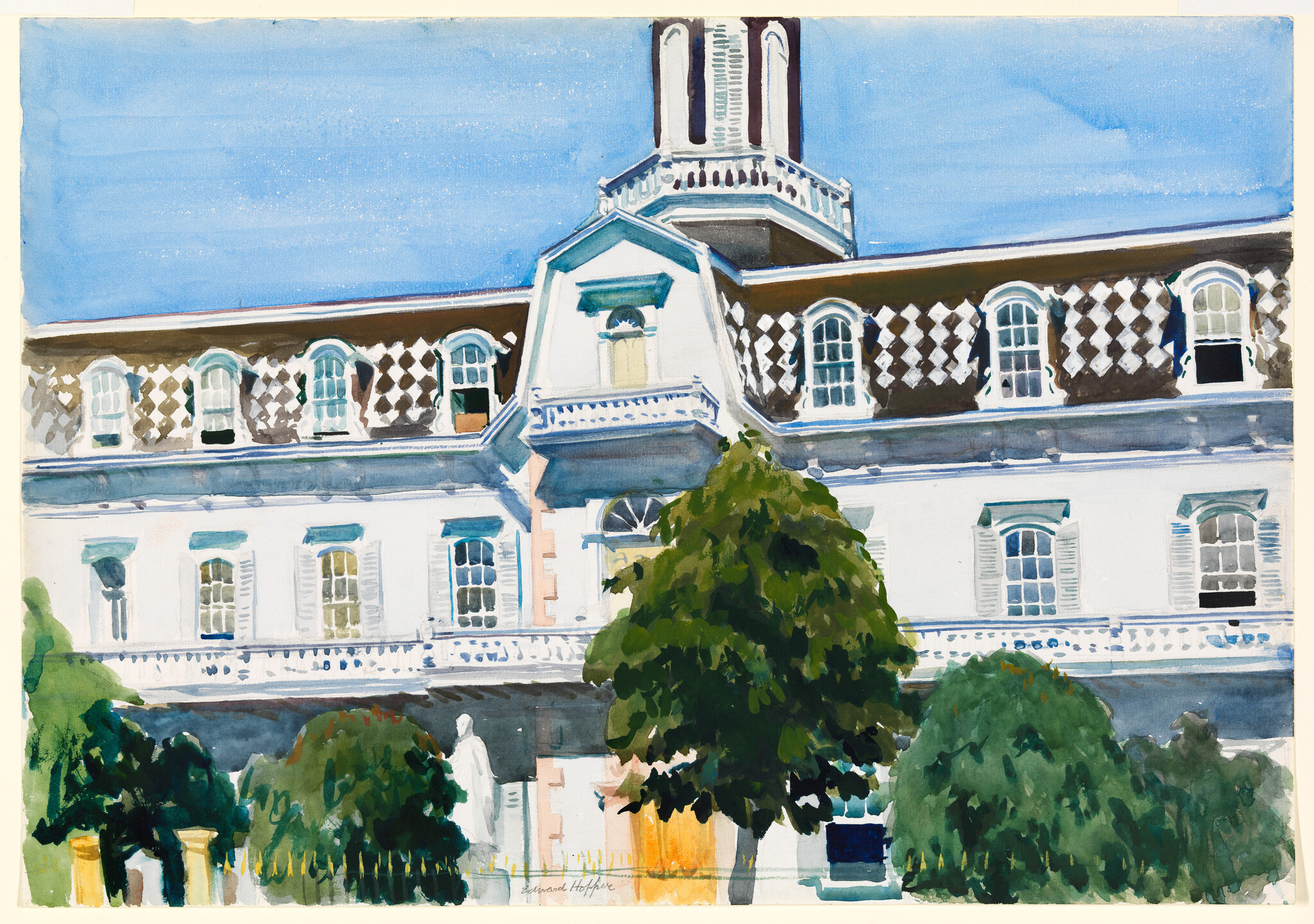 Large white three-story building with diamond-patterned roof and trees in front.