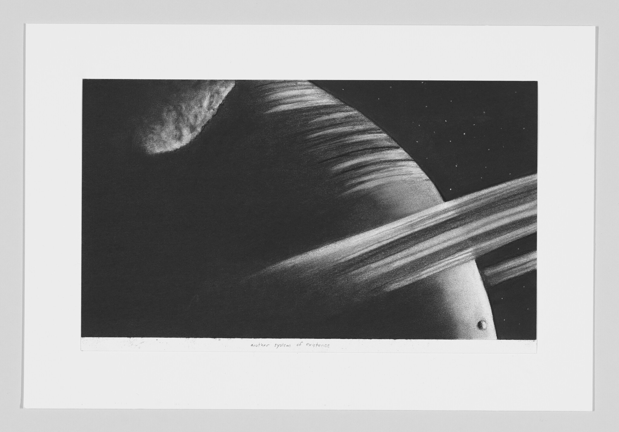 A monochromatic artwork depicting a celestial scene with a large planet and its prominent ring system taking up the majority of the frame, accompanied by a smaller moon or satellite in the foreground. Stars dot the black background. The piece is framed with a white border, and there is handwritten text at the bottom that reads "another system of existence."