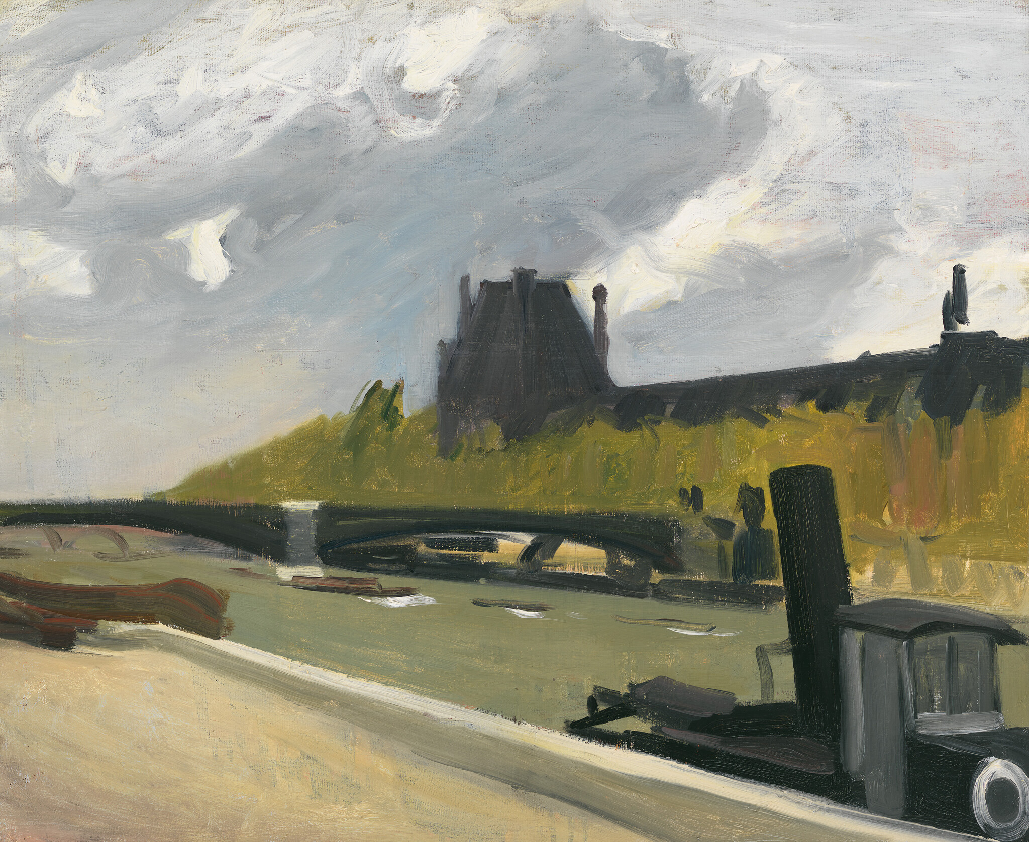 A riverbank scene showing a bridge, moored boats, and a dark riverside building under clouds.