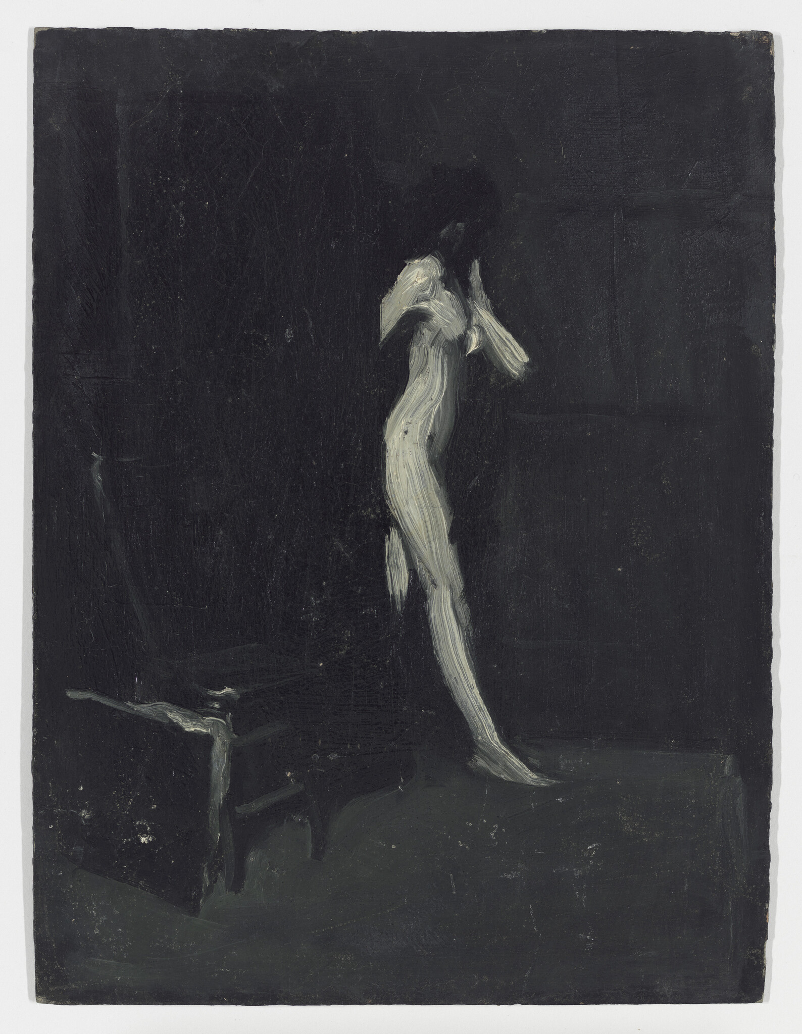 A pale female figure stands on tiptoe in a dark room with a low bench.