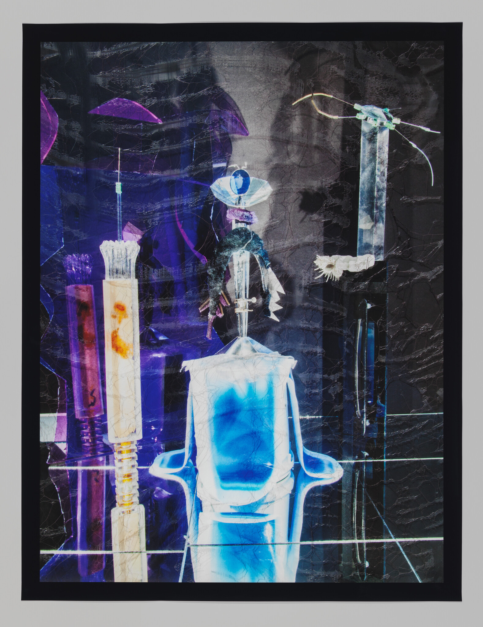 A vibrant mixed media artwork featuring abstract elements in blue and purple hues with contrasting black and white details, encased in a black frame. The composition includes various textures and layers, creating a dynamic visual effect.