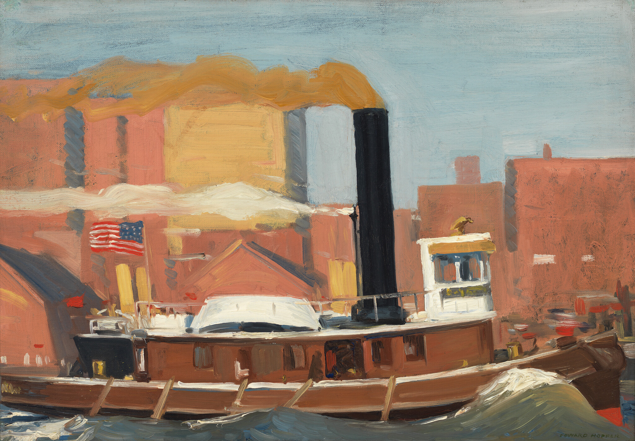 A small steamboat with a tall smokestack and American flag chugs past brick waterfront buildings.