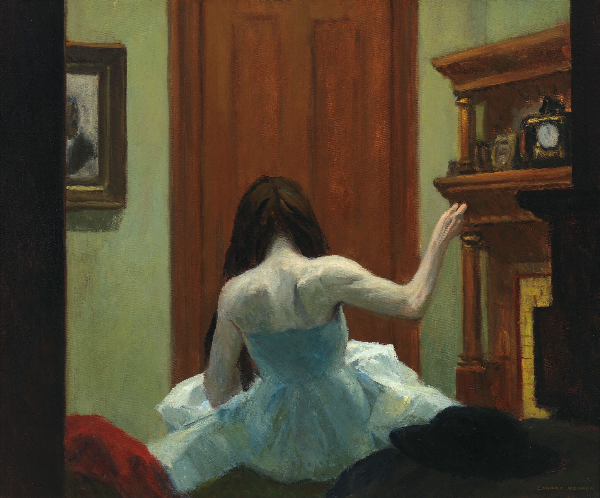 A woman in a white dress sits on a bed, her back to the viewer, reaching for the mantel.