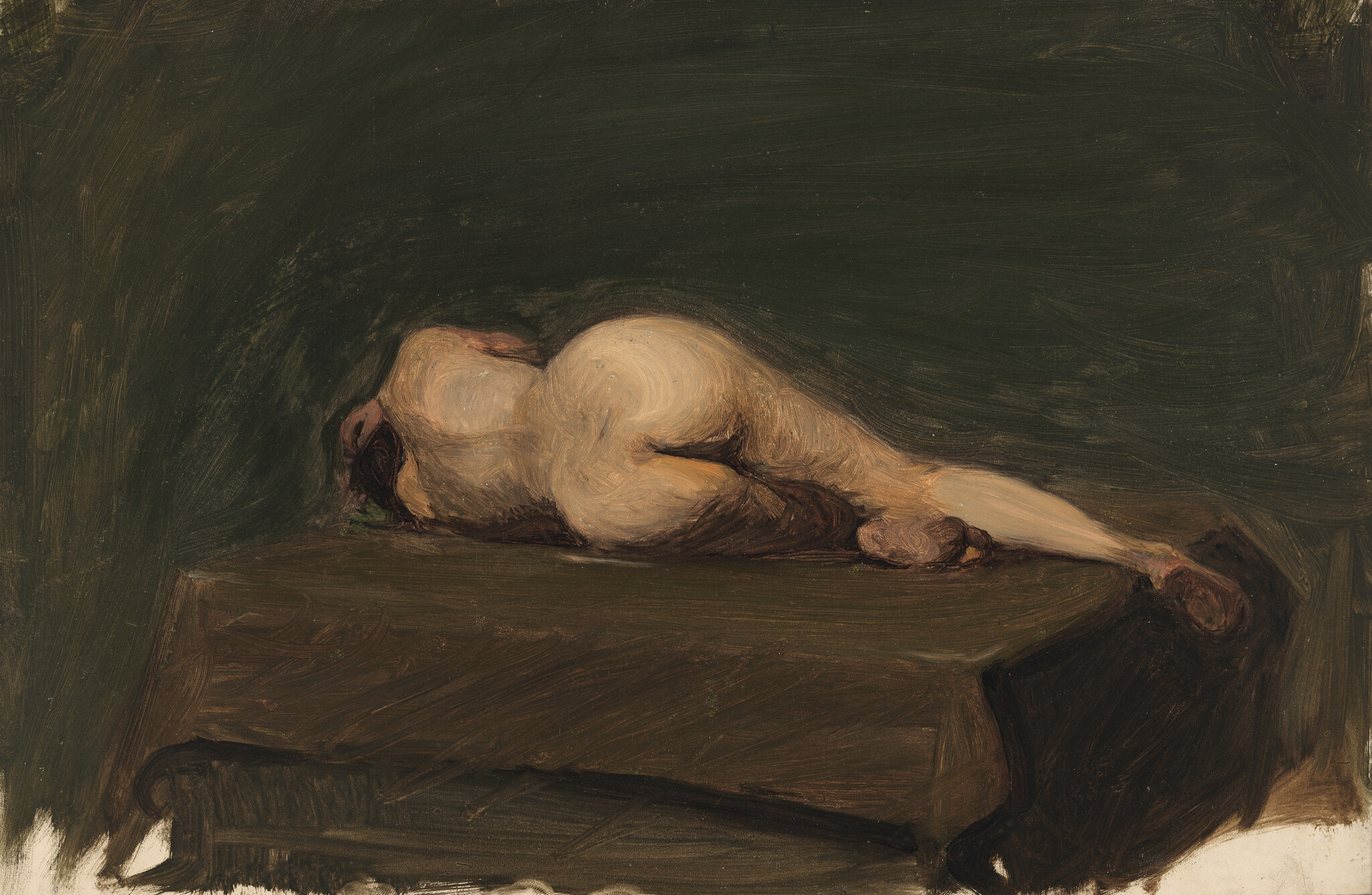 A nude person lies curled on a dark table with legs extended and head turned away.