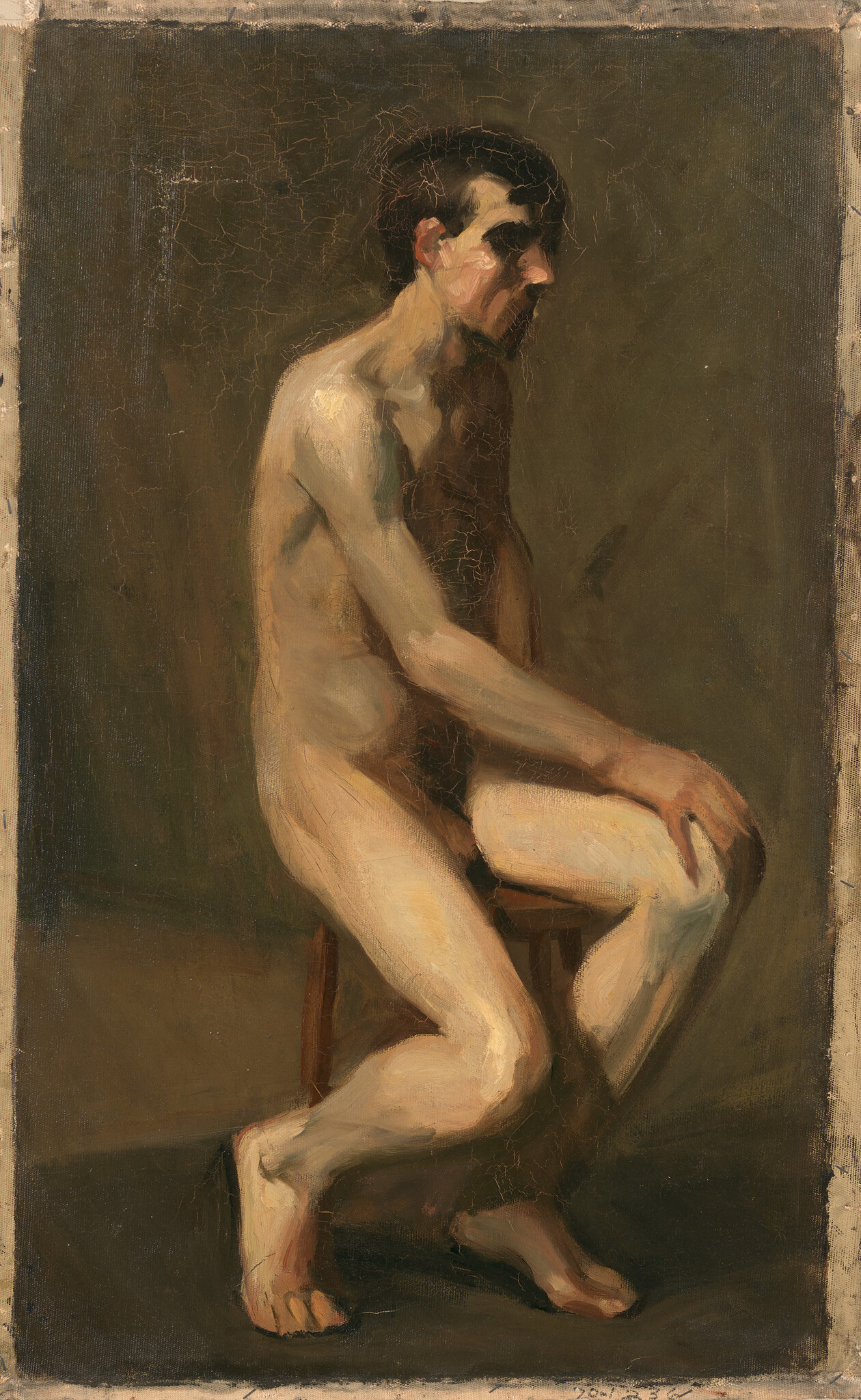 A nude man sits on a stool with hands resting on his knee, looking downward.