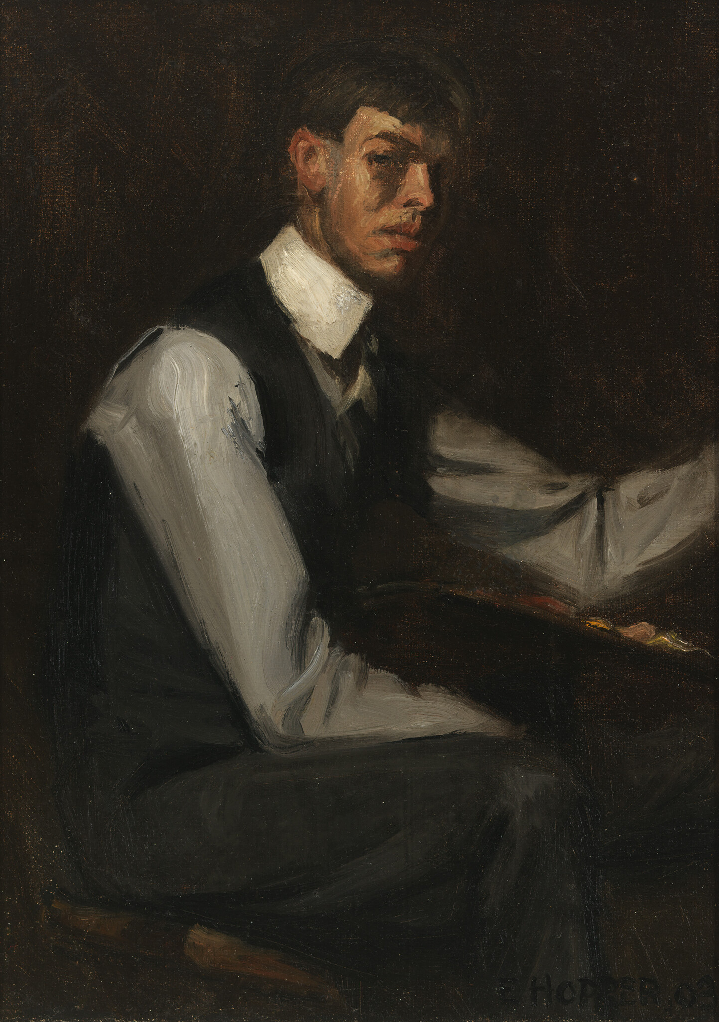 A seated young man in a white shirt and dark vest looks toward the viewer.