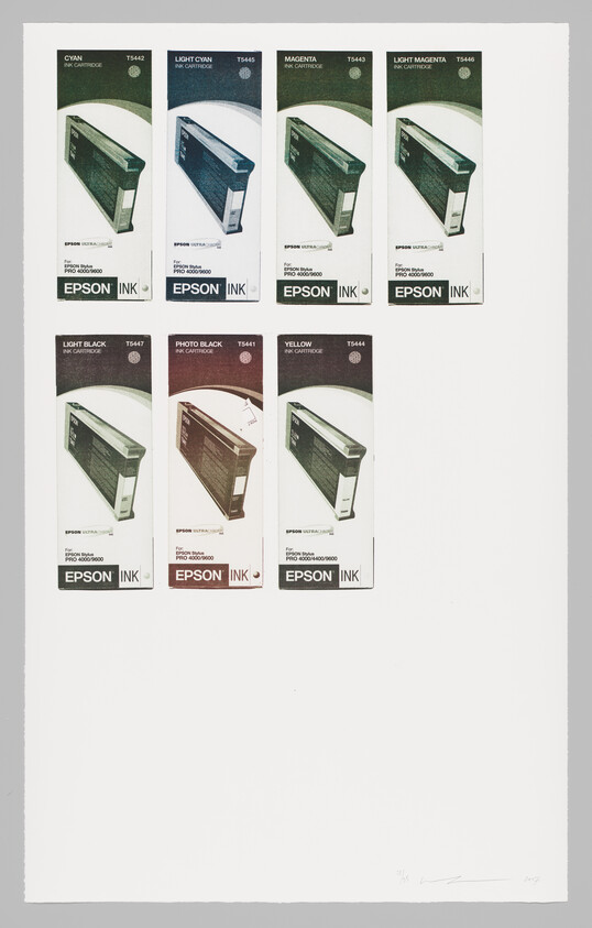 Seven Epson ink cartridge boxes in various colors arranged on a white sheet.