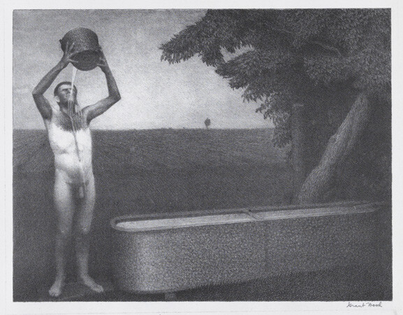 A naked person pouring a bucket of water over their head beside an outdoor bathtub under a tree.