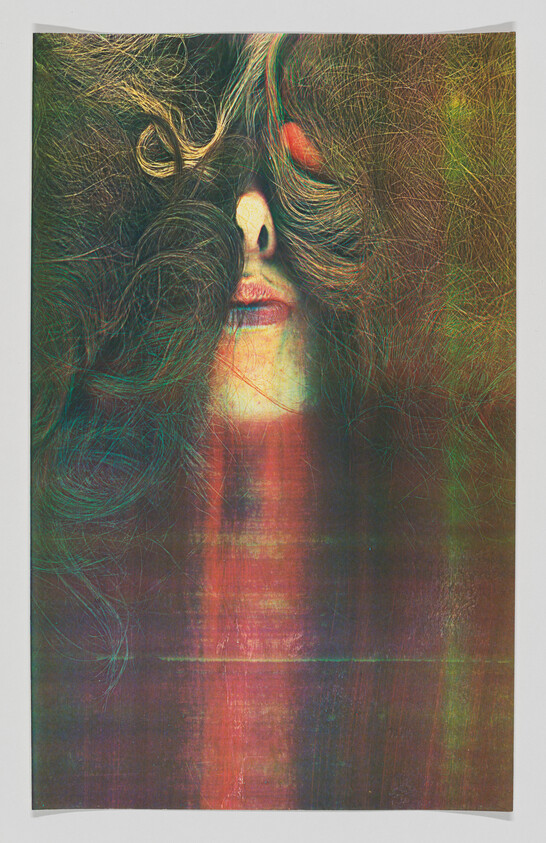 A woman's face partially hidden by thick curly hair with colorful vertical light streaks.
