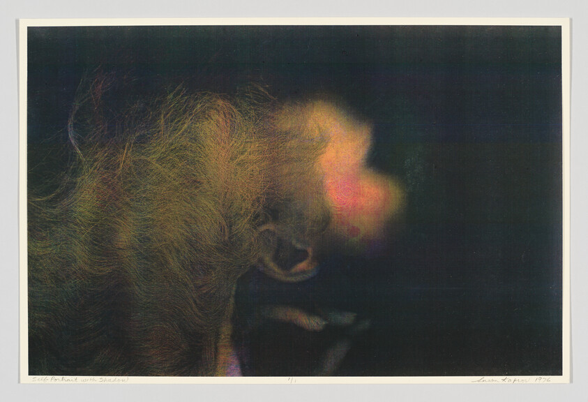 A young person with tousled hair tilts their head back in a dark, colorful abstract portrait.