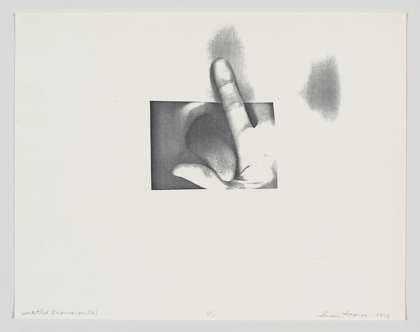 A close-up of a hand making a pointing gesture with smudged pencil marks.