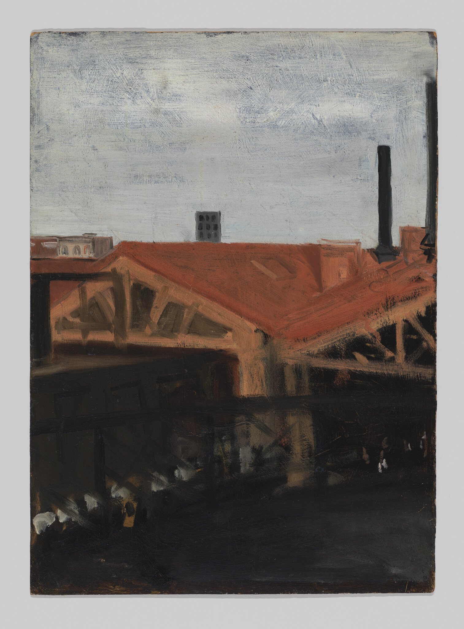 A red-roofed industrial building with a tall smokestack beneath a gray overcast sky.