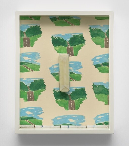 Framed artwork with repeating road-and-lake map motifs and a vertical folded paper sculpture mounted center.