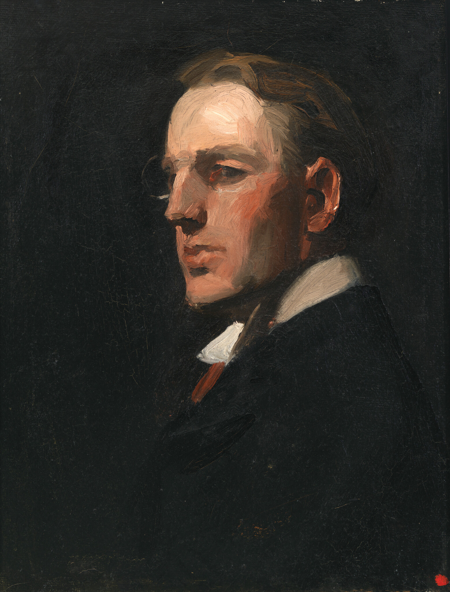 A young man in a dark suit and white collar gazes to the left against a black background.