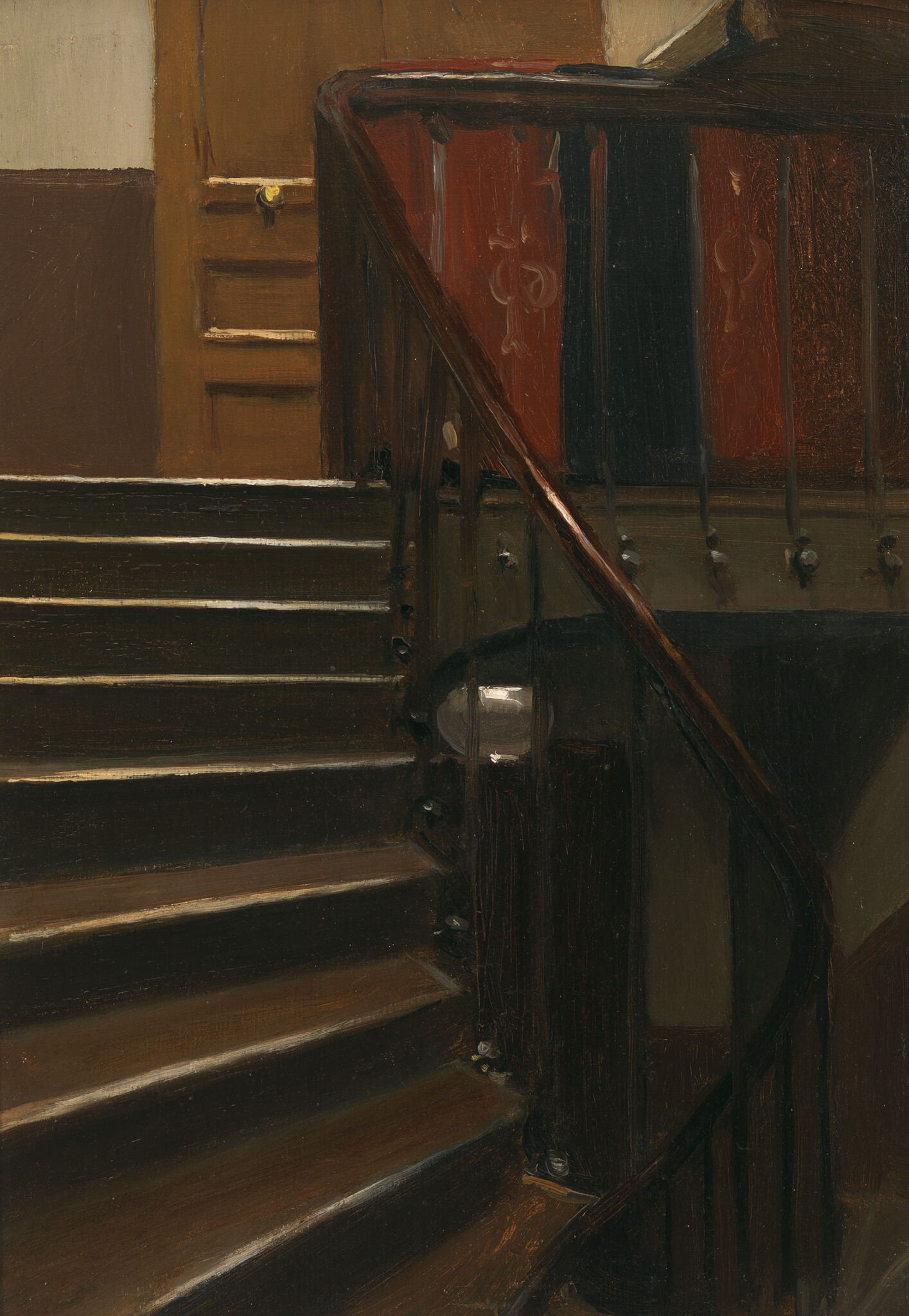 A dim wooden staircase with worn steps and a curved banister leading to a closed door.